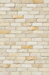 Fototapeta premium Cream, white brick wall texture background featuring meticulous stonework. Light yellow, bronze hues, rough surface, grunge texture provide natural, aged aesthetic for interior design construction