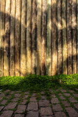 Palm tree shadow on the wooden background and stone sidewalk in Brazil