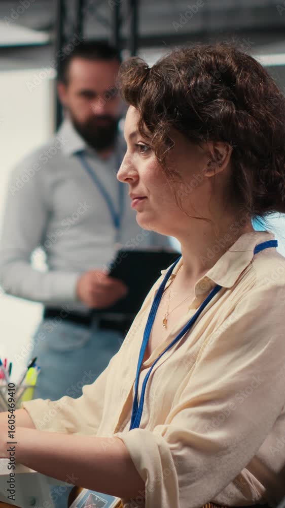 Poster vertical video administrator engages with financial data insights on a computer, developing innovati