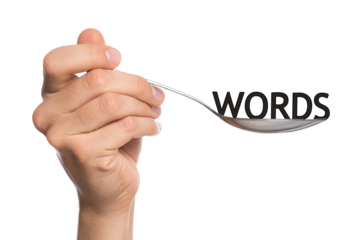 Hand holding a spoon with words word conceptual photo