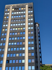 Modern High-Rise Building: Contemporary Urban Architecture Against a Clear Blue Sky