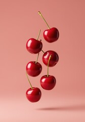Floating cherries on pink background.