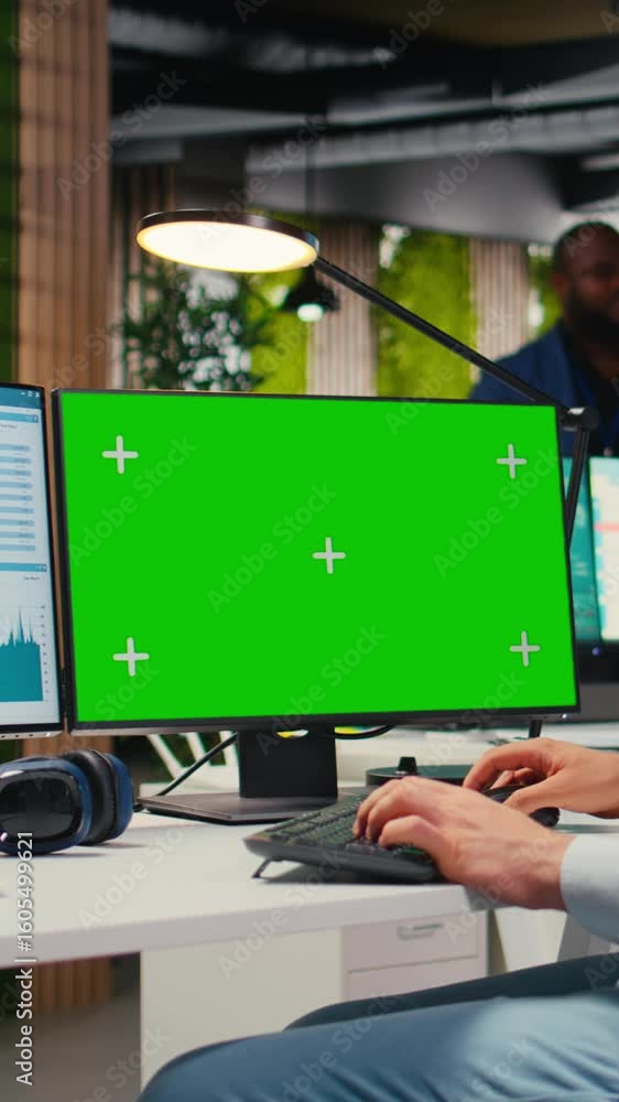 Poster vertical video business manager working on report writing next to chroma key screen, reviewing data 