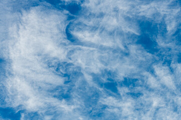 High cloud in the blue afternoon sky
