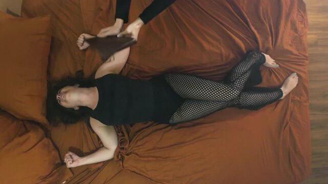 woman writhing on bed during an exorcism