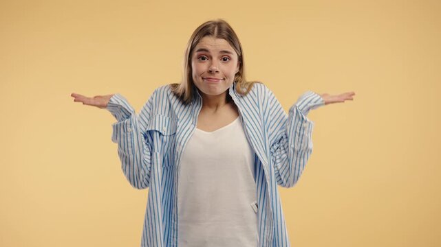 Confused blonde woman shrugs shoulders showing uncertainty, confusion,hesitation