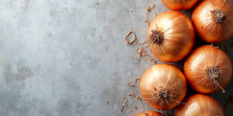 Whole Golden Onions on Textured Gray Background – Rustic Top-Down Food Banner
