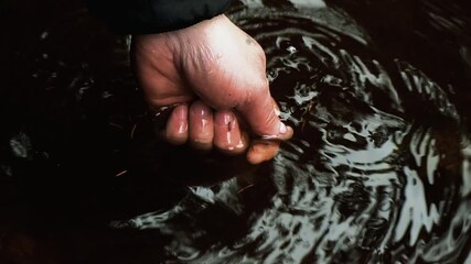 Catch a lucky break. Slip the luck through his fingers. Angler releases trout. A man's hand releases a fish. close-up video. - Powered by Adobe