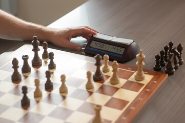 Close up of hands of middle aged caucasian man playing chess. 