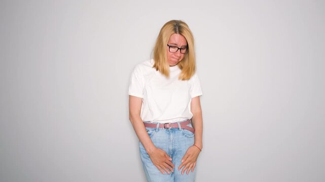 Middle aged woman sneezes unexpectedly and experiences bladder leakage. Her face shows embarrassment and discomfort, raising awareness about emotional impact it can have on daily life and confidence