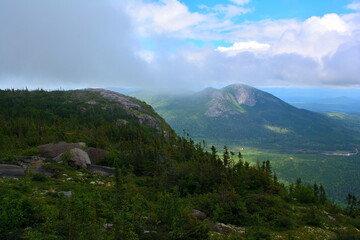 Mountain landscape with dramatic clouds and forest in Charlevoix, Quebec, Canada