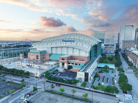 Stunning aerial drone view of Minute Maid Park in downtown Houston, Texas. Captured on a bright day with scattered clouds and vivid blue sky. Photo take 4 14 2025 in Houston, TX.
