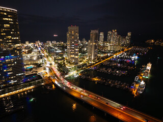 Obraz premium Night view. Yacht club. Marina in night. Summer vacation. Downtown city marina with luxury illuminated yacht. Docked vessels. Luxury yacht in night marina. Luxury yacht at night