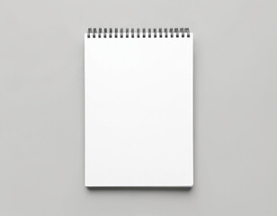 Spiral bound notebook with blank white pages rests on clean gray surface. Open sketchbook perfect for capturing creative ideas, notes, drawings. Minimalist composition, ideal for business, school,