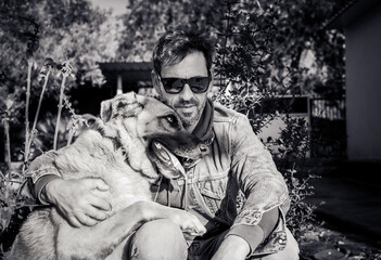 portrait of a man hugging his pet