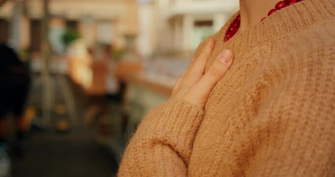 Person practicing mindful breathing outdoors with hand resting gently on chest