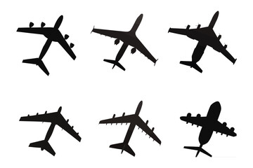 Silhouette of Aircrafts:  A collection of sleek silhouettes of modern airplanes, depicted from multiple angles against a clean backdrop, perfect for illustrating travel, aviation, or transport.