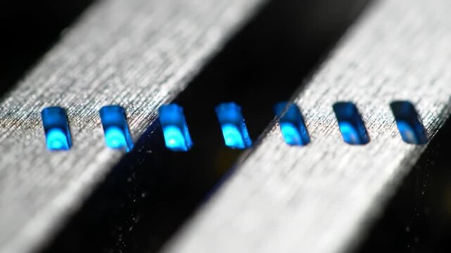 Macro shot of illuminated blue bars on a textured surface