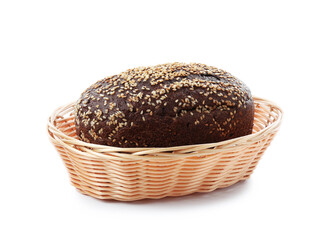 Loaf of rye bread with sesame seeds in basket isolated on white