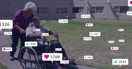 Pushing woman guiding man in wheelchair across yard with social icons, satellite dish, copy space