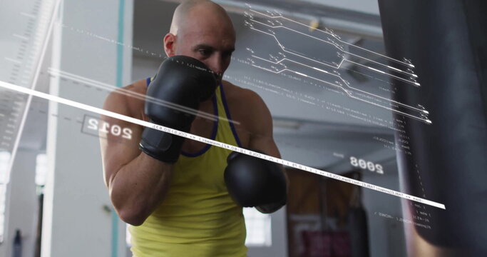 Training boxer in yellow top and boxing gloves hitting punching bag in gym, with digital overlay