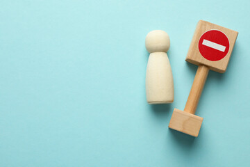 Unemployment. Human figure and stop sign on light blue background, top view. Space for text