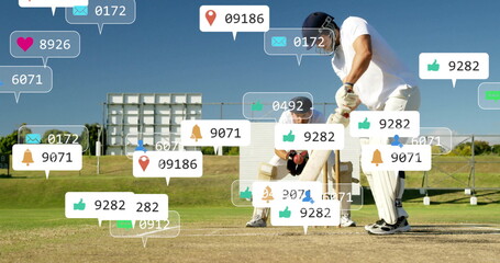 Batsman and wicketkeeper playing cricket in grass field, with wooden bat, stumps and digital icons