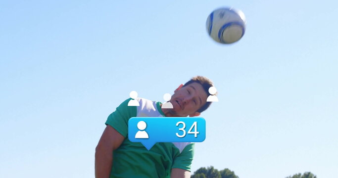 Soccer player wearing jersey jumping and heading ball on field, with overlay icons and bubble - Powered by Adobe