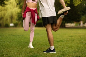 Couple doing morning exercise in park, closeup