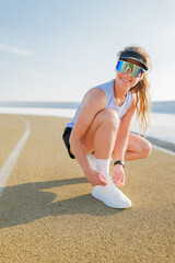 Active woman preparing for a run along the ocean shoreline