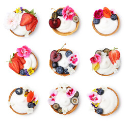 Tartlets decorated with flowers isolated on white, set. Top view. Tasty dessert