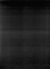 Fototapeta premium A dark, grainy, abstract image with faint horizontal lines and subtle light variations, evoking a sense of mystery or digital noise.
