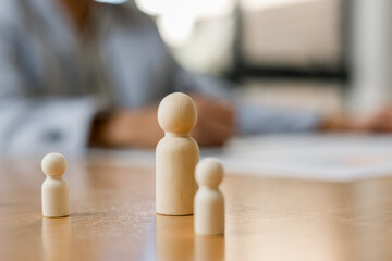 The leader, wooden figure leading the team with business icon on wood block Business strategy with...