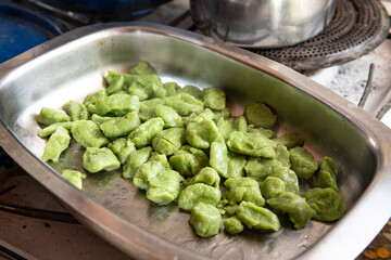 A close-up green gnocchi straight from the pot