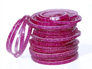 A stack of vibrant red onion slices on a crisp white surface