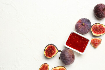 Bowl of sweet fig jam on white background