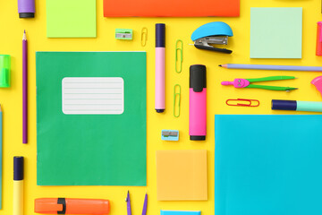 Composition with different stationery on yellow background