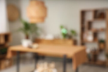 Blurred view of spa salon with massage table and shelf units