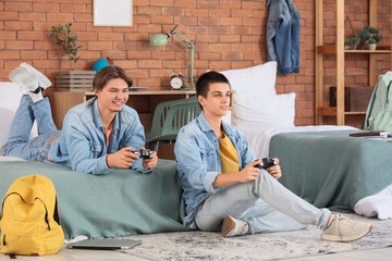 Male students playing video game in dorm room