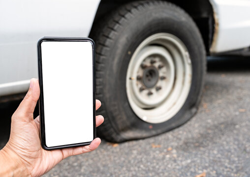 Hand holding a phone with a blank white screen, auto service apps, insurance, or transportation problems.