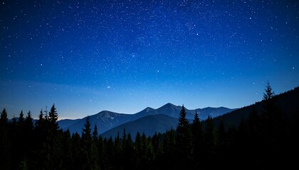 Nighttime vista of serene mountains under a canopy of stars in a pristine dark sky