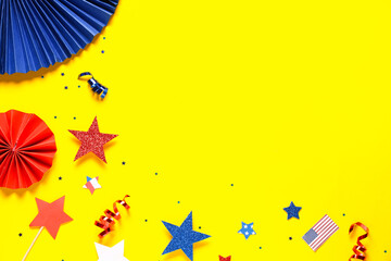 Paper fans with stars and confetti in colors of USA flag for Independence Day on yellow background