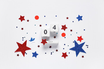 Calendar with date of Independence Day and paper stars in colors of USA flag on white background