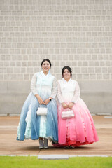 In Seoul in June 2025, a Korean woman in her twenties wearing a charming pink hanbok poses for a...