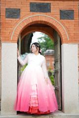 In Seoul in June 2025, two Korean women in their twenties wearing pink and sky-blue hanbok stand in...