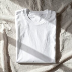 Folded White T Shirt on Neutral Fabric Under Soft Light in a Still Life
