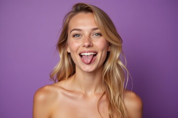 Woman with blonde hair sticking out her tongue.