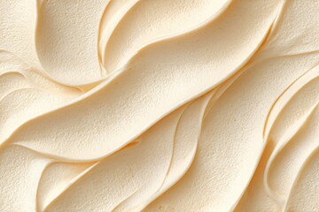 Creamy swirls of pale yellow soft serve ice cream or whipped topping. Delicious frozen dessert texture. Food background.