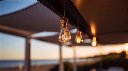 Golden sunset glow illuminating a beach restaurant with soft reflections of string lights.