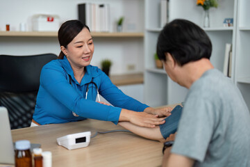 Fototapeta premium Doctor measuring blood pressure of patient in clinic